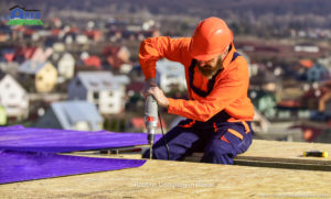 Materials requirements. Install partially overlapping layers of material over roof insulation surfaces. Master repair roof. Flat roof installation. Roofer constructing roof. Man roofing surface